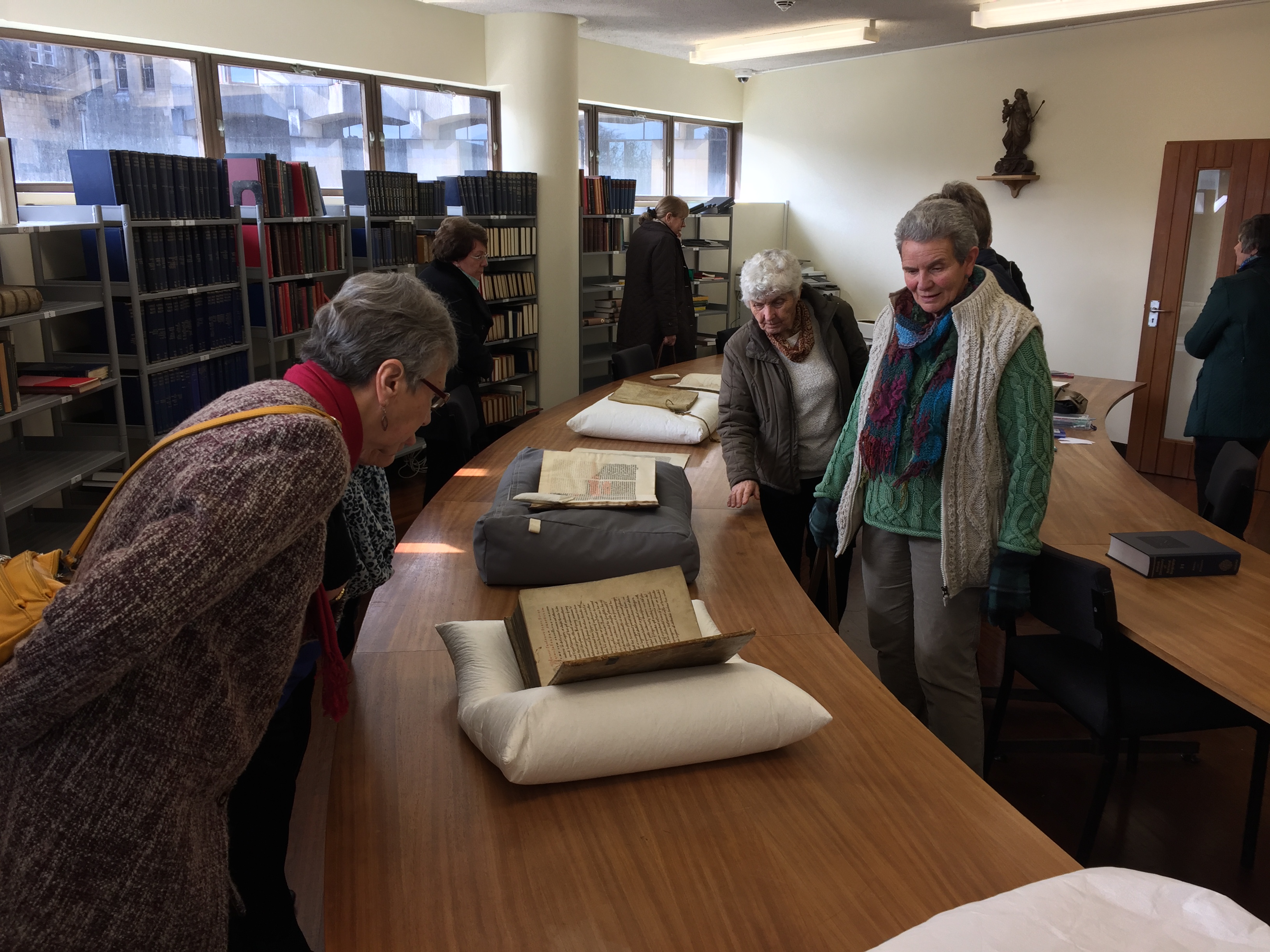 Abbey volunteers looking at old books